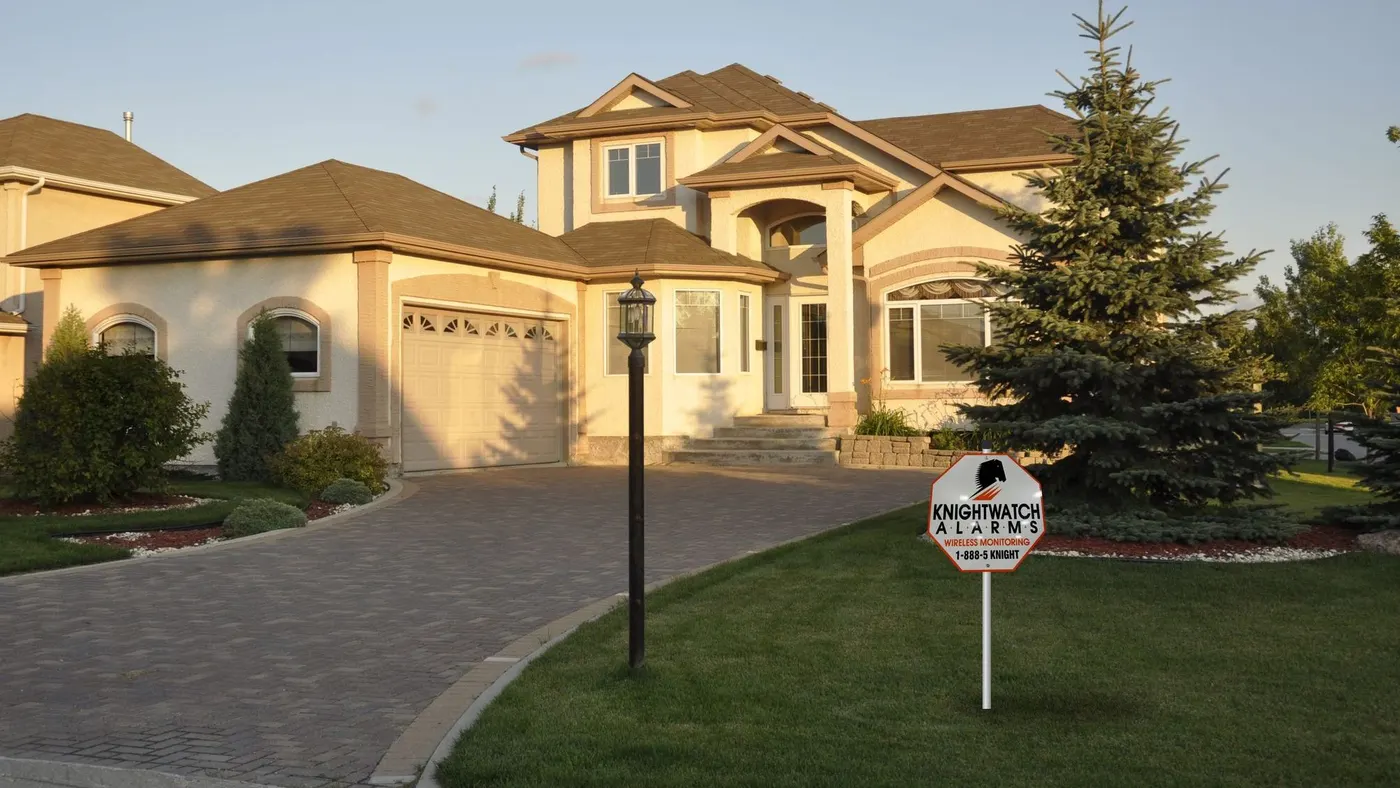 Executive home protected by Knightwatch Alarms, lawn sign in the front yard