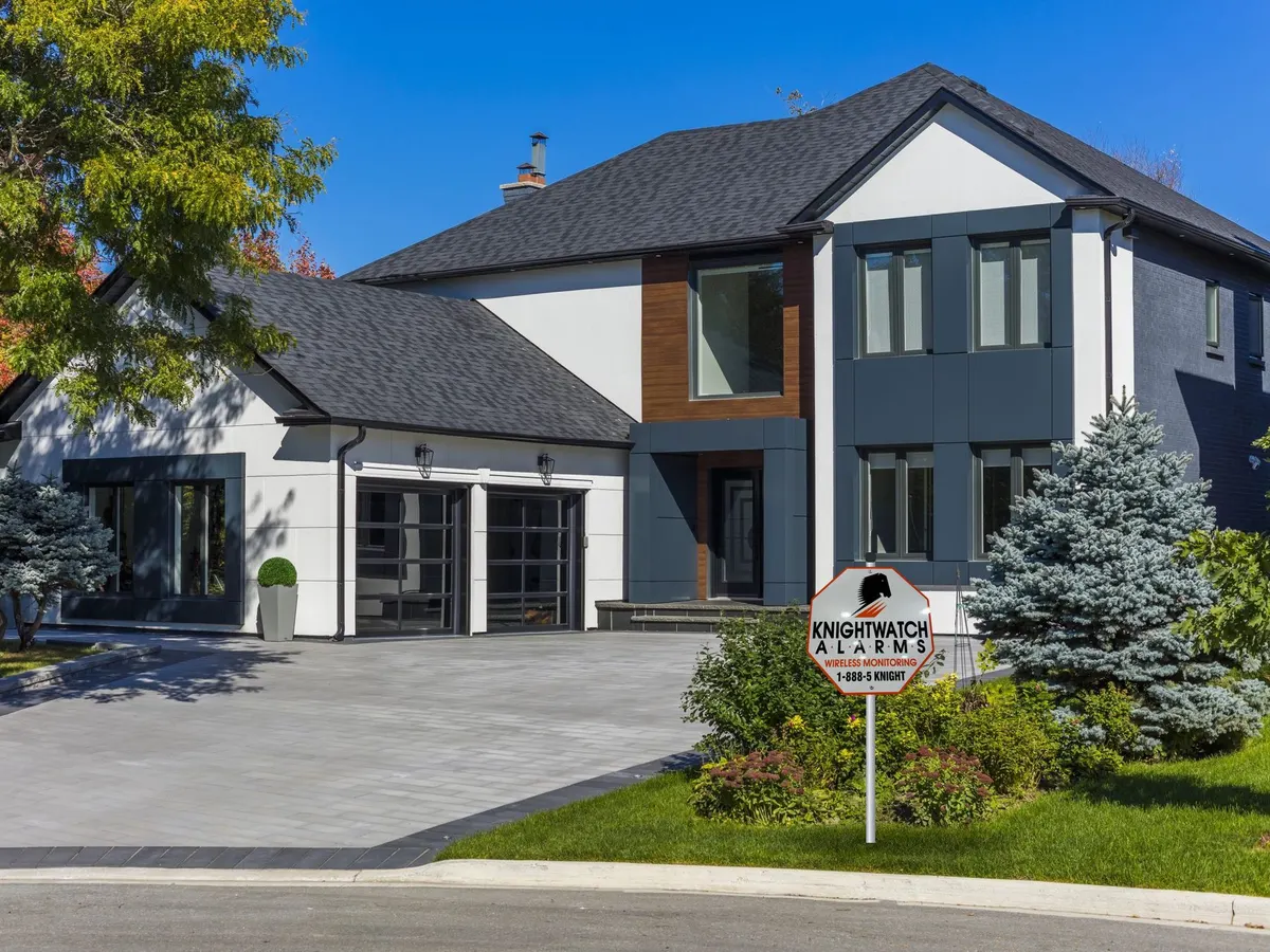 Modern luxury home with a Knightwatch Alarms lawn sign