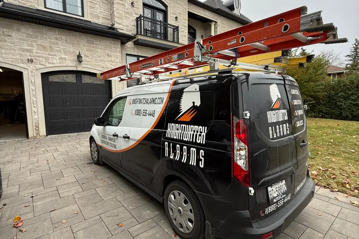 Knightwatch Alarms service van parked at a client's home