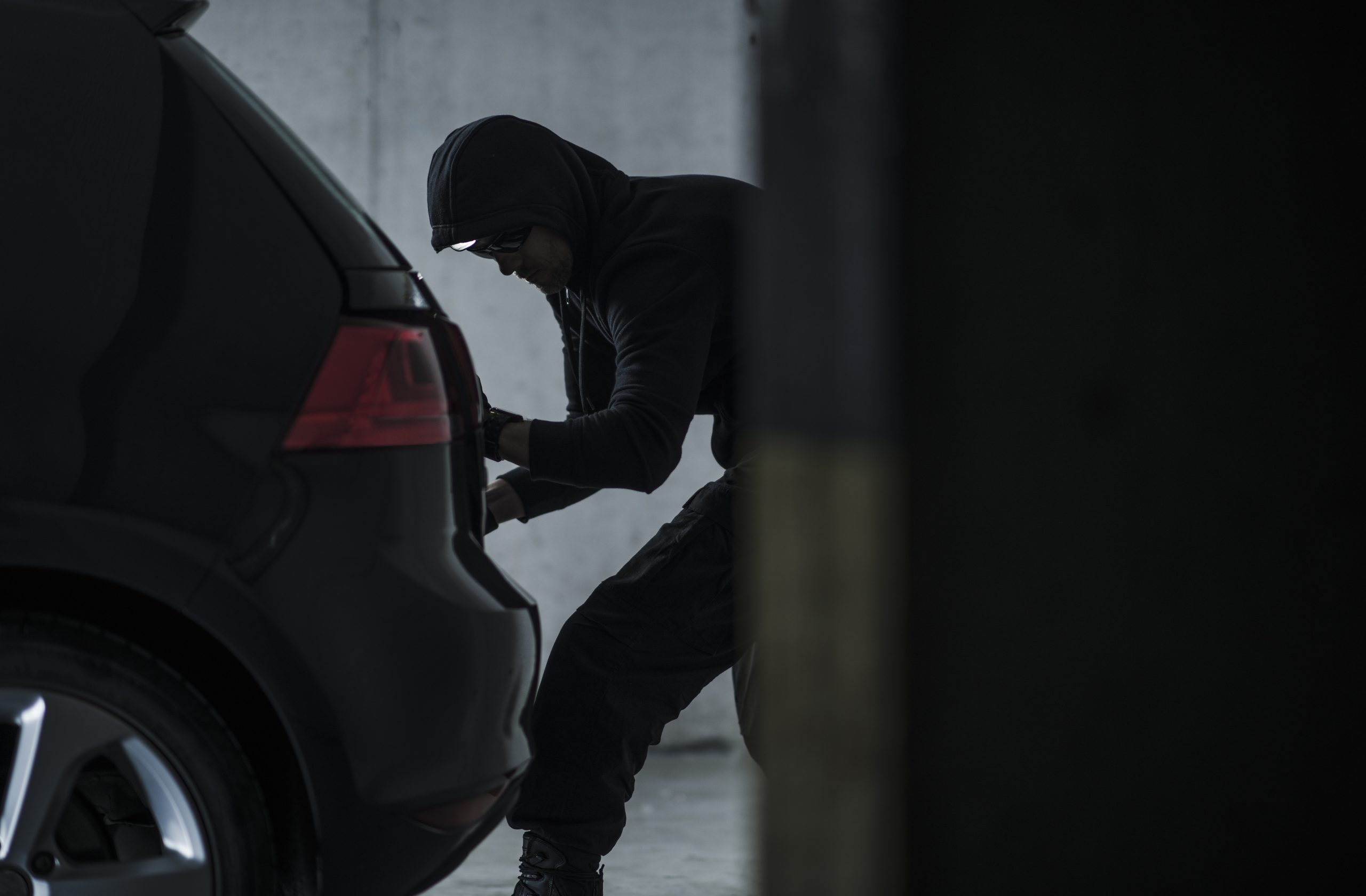 Car thief stealing vehicle